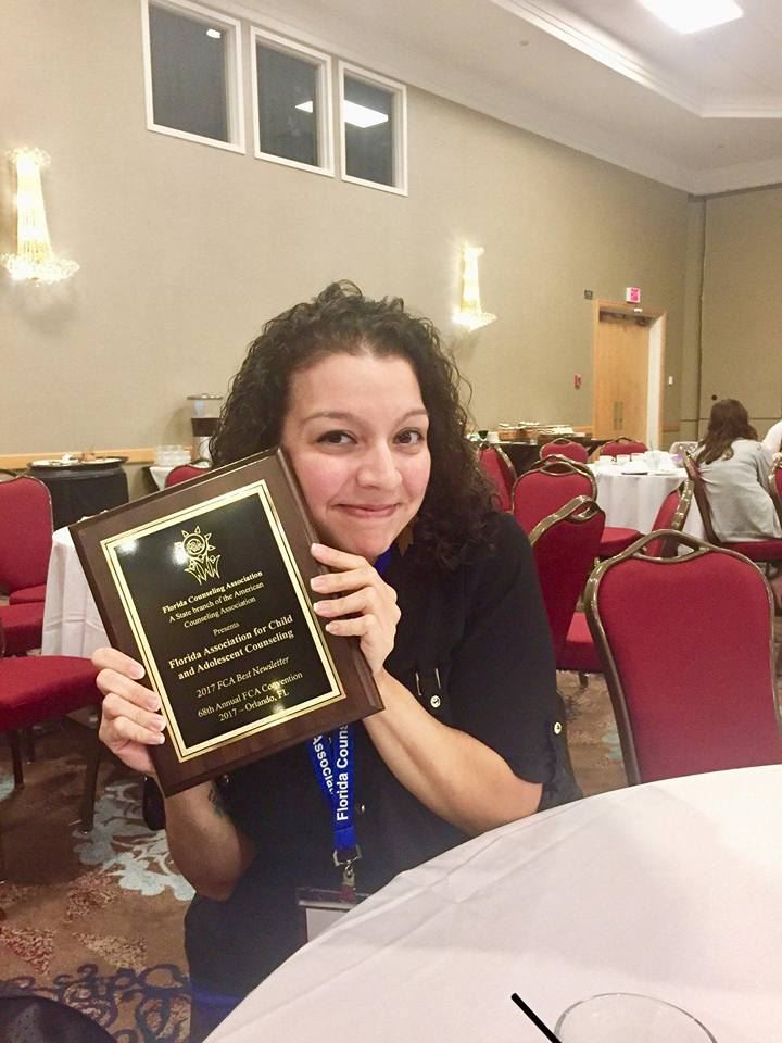Louse Soto with FACAC Award for 2017 Best Newsletter